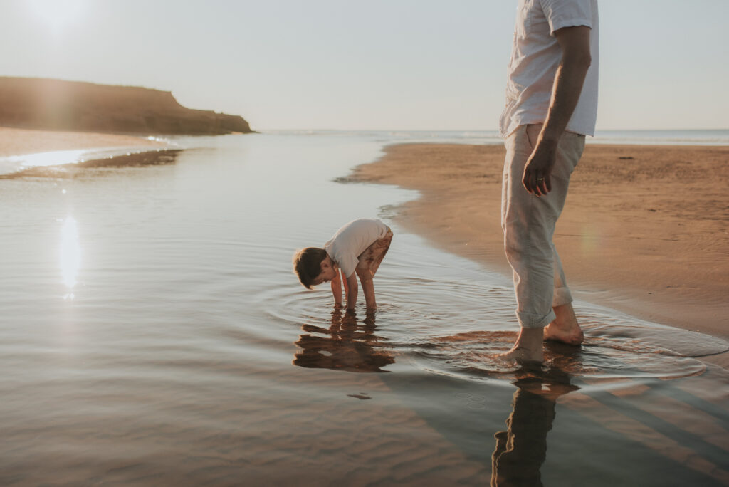 Family explores a PEI beach while taking family photos.