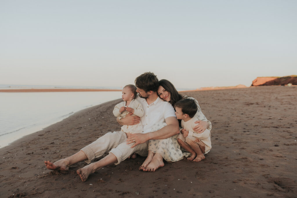 Family explores a PEI beach while taking family photos.