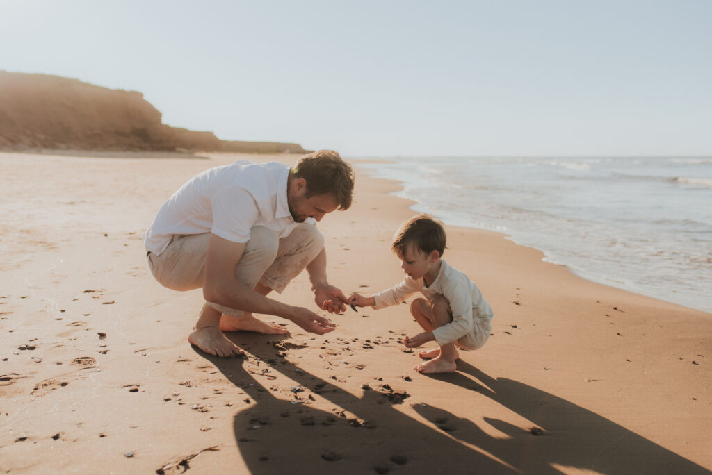 Family explores a PEI beach while taking family photos.