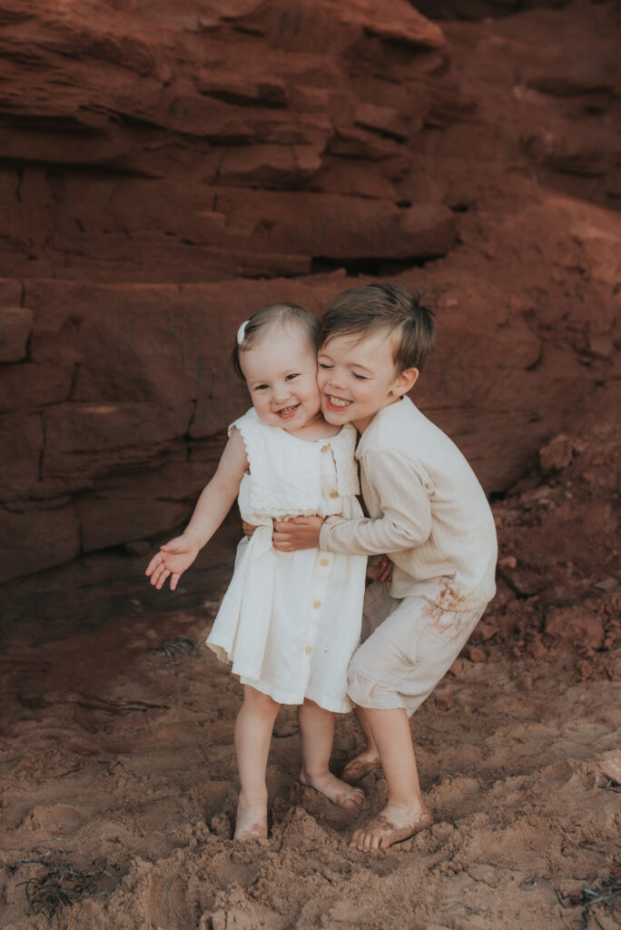 Family explores caves on a PEI beach.