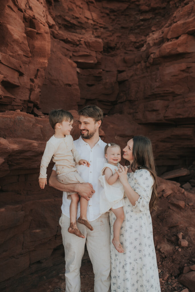 Family explores caves on a PEI beach.