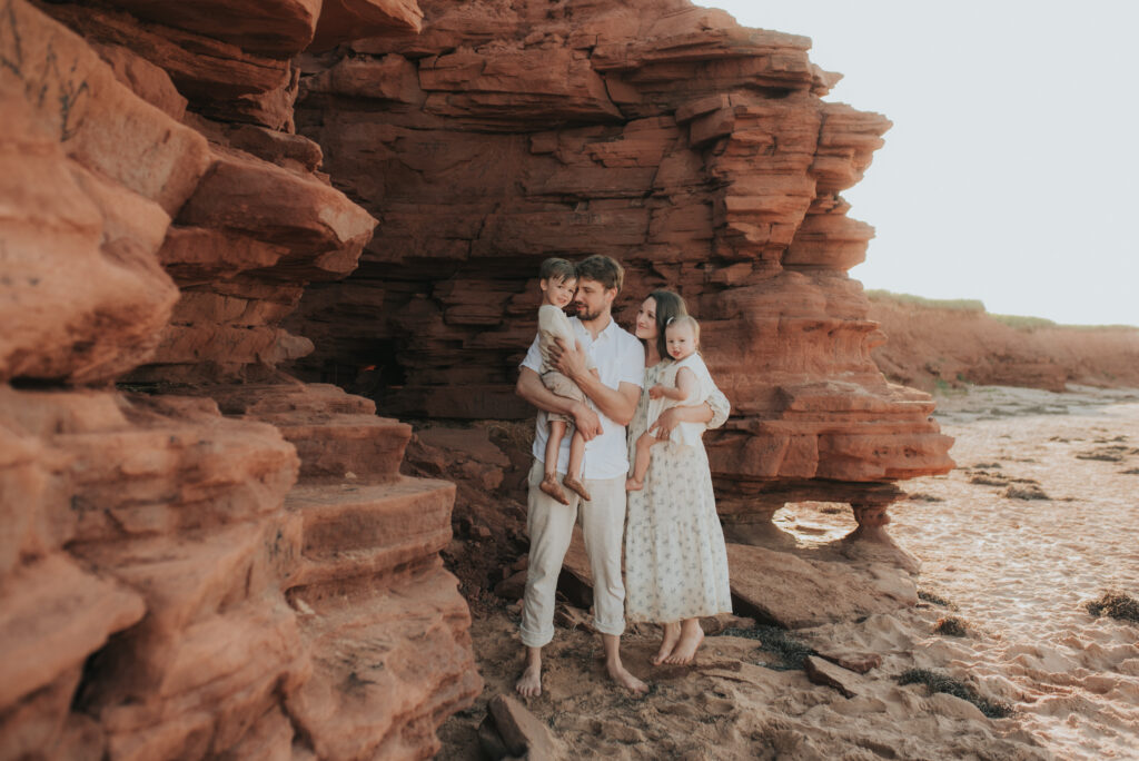 Family explores caves on a PEI beach.